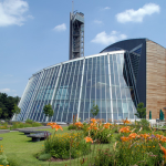Photo of the exterior of the pequot museum's sunroom and ballroom area with the tower in the background.